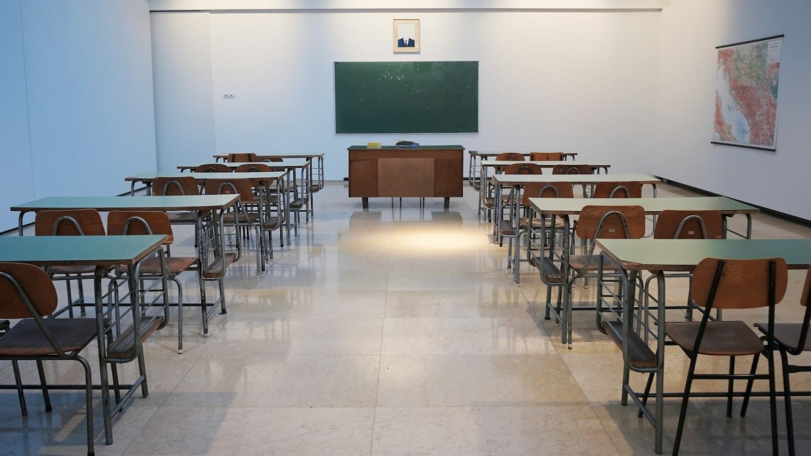 Empty classroom with desks and a chalkboard